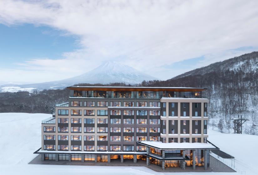 The exterior of a 6 story hotel surrounded by snow