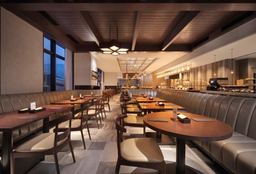 A hotel dining area with kitchen to the right